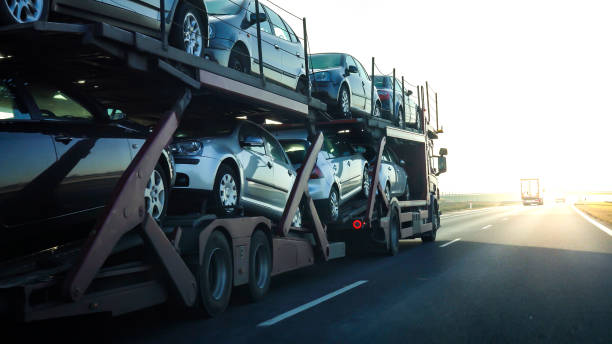 Used or new cars being transported on a long vehicle car carrier.